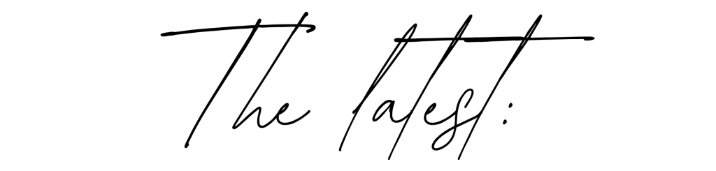 Stylized text displaying 'The Latest:' in a cursive font.